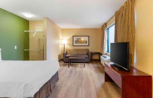 a hotel room with a bed and a television at Extended Stay America Suites - Sacramento - Vacaville in Vacaville