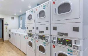 a bunch of washing machines in a laundry room at Extended Stay America Select Suites - Wilmington - West in Wilmington