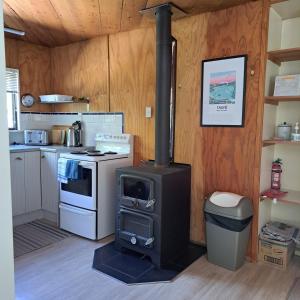 a kitchen with a wood stove in a room at The Homestead in Taupo