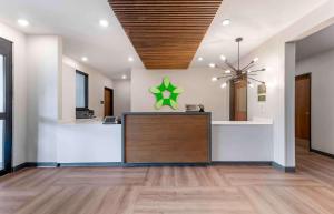 an office lobby with a reception desk and a chandelier at Extended Stay America Suites - Huntsville - Madison in Madison