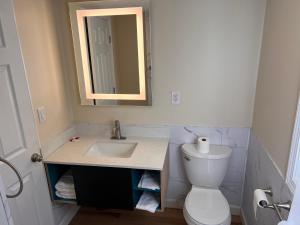 a bathroom with a sink and a toilet and a mirror at The Inn of Dayville in Dayville
