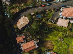 an overhead view of roofs of houses and a road at Madeira Surf Lodge in São Vicente