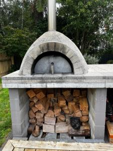 a stone oven with fire wood in it at Walk to Town from this Modern and Warm Home in Central Cambridge Four Beds Available in Cambridge