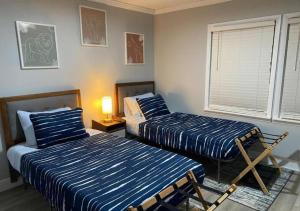 a bedroom with two beds and a window at Modern 2BR Aparment near NC ZOO w Parking in Asheboro