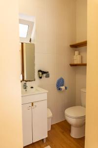 a bathroom with a toilet and a sink at Madeira Surf Lodge in São Vicente