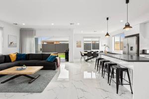 a kitchen and living room with a couch and a table at Amazing family home opposite a park & sleeps 10 in Saint Leonards