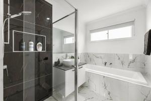 a bathroom with a glass shower and a sink at Amazing family home opposite a park & sleeps 10 in Saint Leonards +7 photos