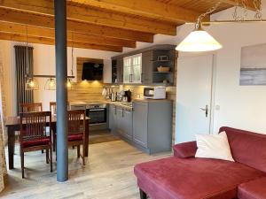 a living room with a couch and a kitchen at Inselsonne Haus Inge - Fewo Inge in Breege in Breege
