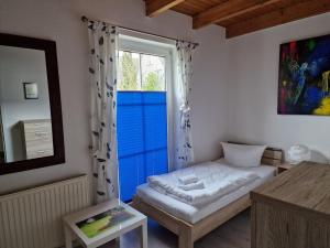 a small room with a bed and a window at Inselsonne Haus Inge - Fewo Inge in Breege in Breege