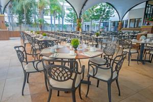 a row of tables and chairs in a restaurant at Adams Beach Hotel & Spa in Ayia Napa