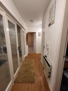 a hallway with a phone on the wall and a hallway with a hallwayngthngth at Lovely apartment with free parking & Wi-Fi in Birmingham