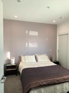 a bedroom with a large bed and two night stands at Location, location, location! in Napier