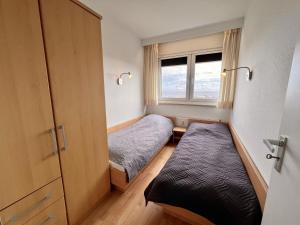 a small room with two beds and a window at Berolina 519 - Ostsee Weitblick in Dahme +14 photos