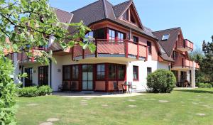 a large house with a lawn in front of it at Oewern Diek App 52 in Wustrow