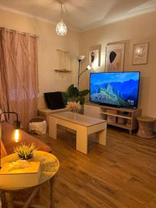 sala de estar con TV de pantalla plana grande en Apartamento Yeyé en Asturias, en Corigos