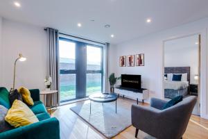 a living room with a couch and chairs and a bed at Remarkable 2-Bed Apartment in Birmingham in Birmingham