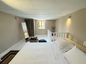 a bedroom with a large white bed and a mirror at Opṓra in Ermoupoli