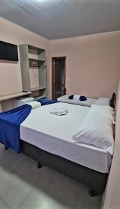 a bedroom with a large bed in a room at Pousada Villa Sambaqui in Penha +1 photo