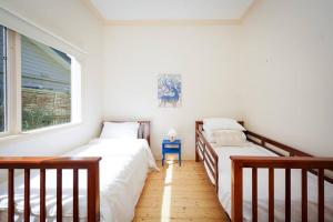 a bedroom with two beds and a window at Twilight Villa - 3 bedroom house in Box Hill in Box Hill