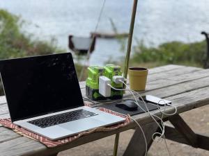 a laptop computer sitting on top of a picnic table at Island Tent Overlook in Maine in Monmouth
