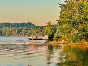 a small plane is floating on a body of water at Island Tent Overlook in Maine in Monmouth