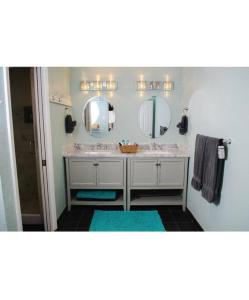 a bathroom with two sinks and two mirrors at Fun Festive House to Gather in Eugene