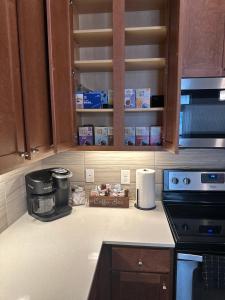 a kitchen counter with a coffee maker and a microwave at Downtown Houston Cozy Queen Suite in Houston