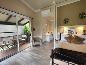 a bedroom with a bed and a sliding glass door at Hidden Valley Private Guest Suite with Views in South Grafton