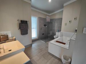 a bathroom with a toilet and a sink and a shower at Hidden Valley Private Guest Suite with Views in South Grafton