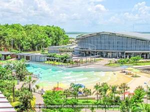 an artist rendering of the expansion of the convention centre water park resort at Zen Marina: 1-BR Executive Apartment By The Bay in Larrakeyah
