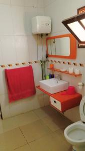 a bathroom with a sink and a red towel at House Cidadela in Praia