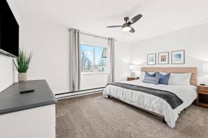 a white bedroom with a bed and a window at 1BR Pet-Friendly Apartment with King Bed in Royal Oak