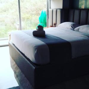 a bedroom with a bed with a large window at 360* Ultimate Penthouse Entire TOP FLOOR and RESORT with GREAT AMENITIES in Kamala Beach