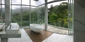 a bathroom with a tub and a large window at 360* Ultimate Penthouse Entire TOP FLOOR and RESORT with GREAT AMENITIES in Kamala Beach