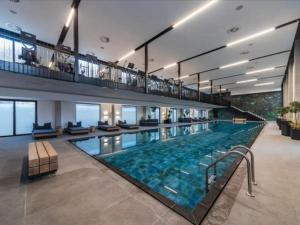 a large swimming pool in the middle of a building at Hyde Park Sandton Luxury 2BR Top Floor in Johannesburg