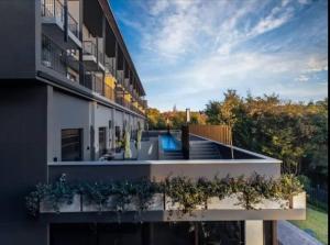 an external view of a building with a swimming pool at Hyde Park Sandton Luxury 2BR Top Floor in Johannesburg