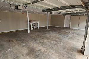 an empty room with a table in the middle at Entire Home w/ Free Wi-Fi, Garage, Deck, Yard in Nixa