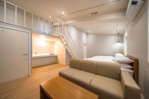 a small room with a couch and a staircase in it at MONO HOTEL in Suwon +39 photos