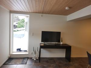 a living room with a flat screen tv on a wall at Fjordclaw SNM- adjoining the Bergen city & Nature in Bergen