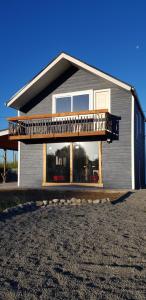 a house with a large balcony on top of it at Rancho Eben Ezer in Puyehue