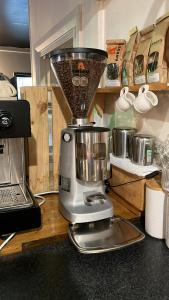 a blender sitting on a counter next to a laptop at B-Ks Premier Motel Palmerston North in Palmerston North