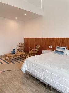 a bedroom with a large bed and a wooden wall at Casa Z Paracas in Paracas