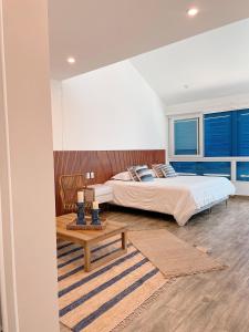 a bedroom with a king sized bed and a table at Casa Z Paracas in Paracas