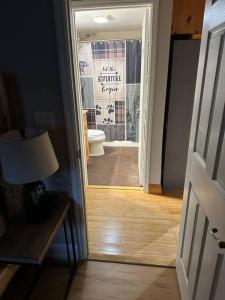 an open door to a bathroom with a toilet at The Dream Road Escape Cabin and Hot Tub in Hendersonville +33 photos