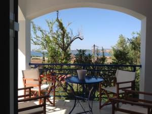 a balcony with a table and chairs and a view at Villa Andrea in Gialova
