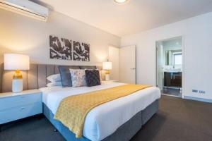 a bedroom with a large bed and a window at Sleek Inner-City Getaway in Prime Location in Sydney