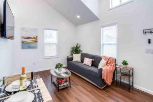 a living room with a couch and a table at Tiny Home w/ King Bed mins DTWN in Rochester