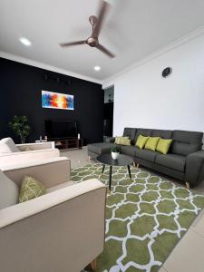 a living room with a couch and a tv at Calma Villa @ Pendang in Pendang