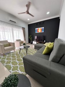 a living room with a couch and a ceiling fan at Calma Villa @ Pendang in Pendang