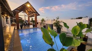 a swimming pool in the middle of a house at Calma Villa @ Pendang in Pendang